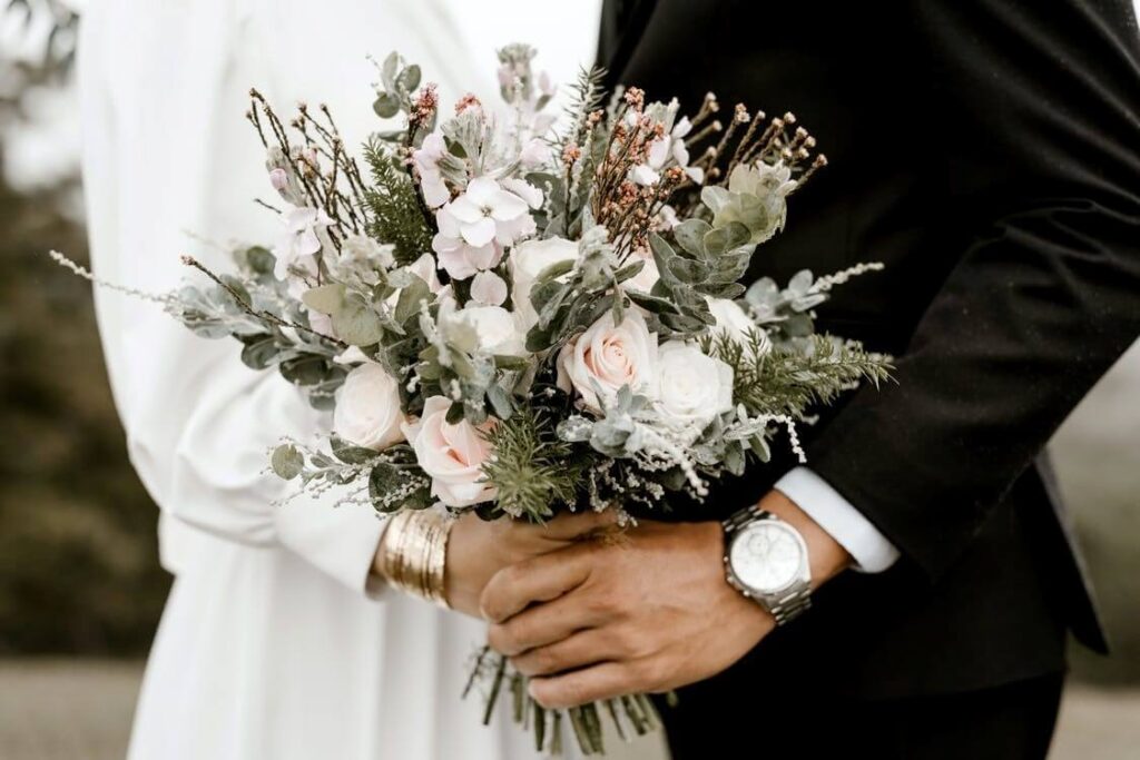 men and women holding beautiful flowers bouquet